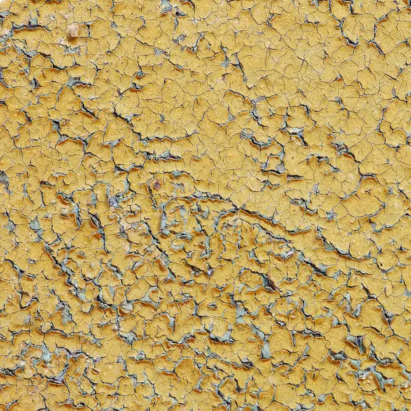 Yellow aged wall with cracks
