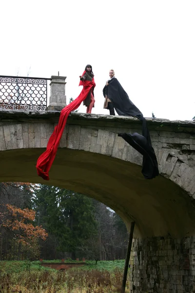Witch with fabric in old bridge