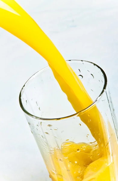Juice is poured into a glass