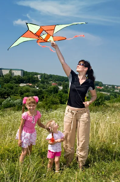 Happy family and children fly kite.