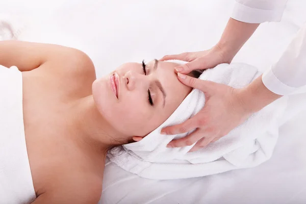 Young woman in spa. Facial massage.