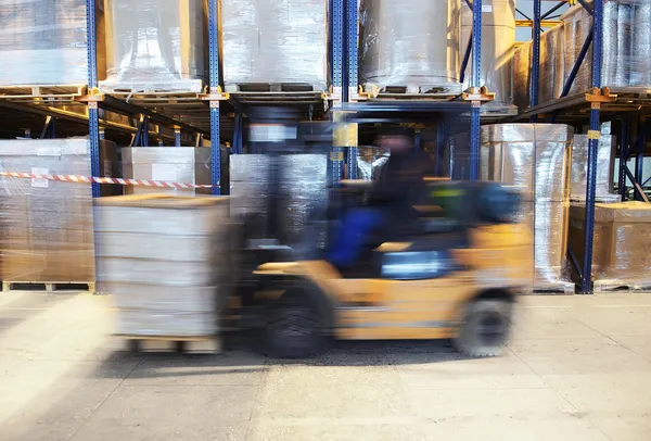 Forklift in motion at warehouse