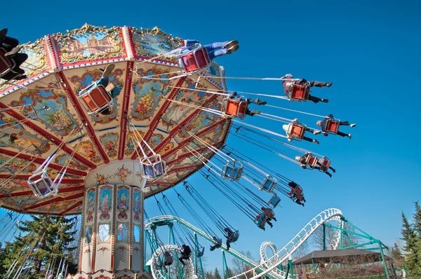 Action photo of carousel on blue sky