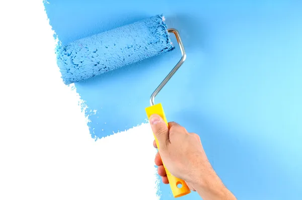 Blue color painting wall with roller