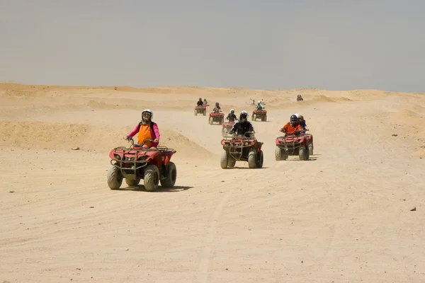 Race on quad in desert