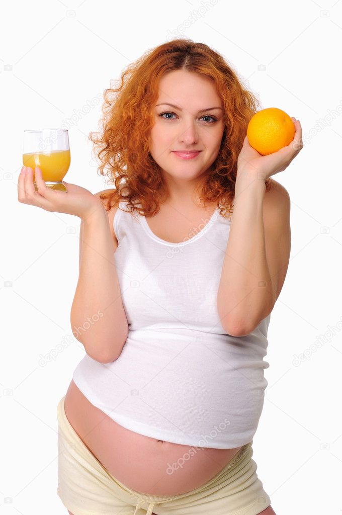 Young redhead pregnant mom thinks about healthy food