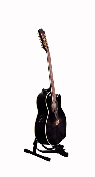 Black guitar on a stand
