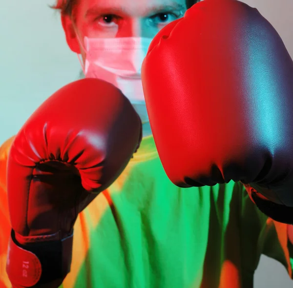 Doctor in red boxing gloves fighting against influenza
