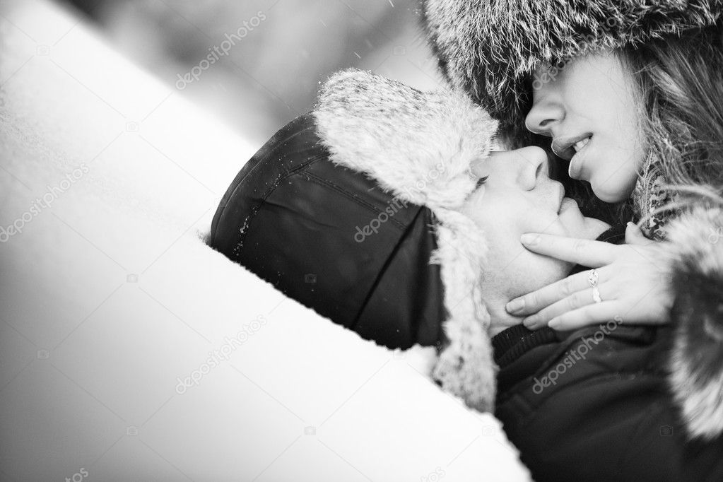 Young couple kissing on snow  Stock Photo #3071655