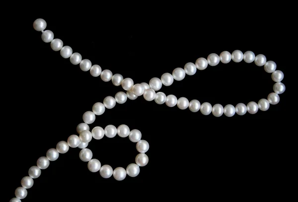 White pearls on the black velvet