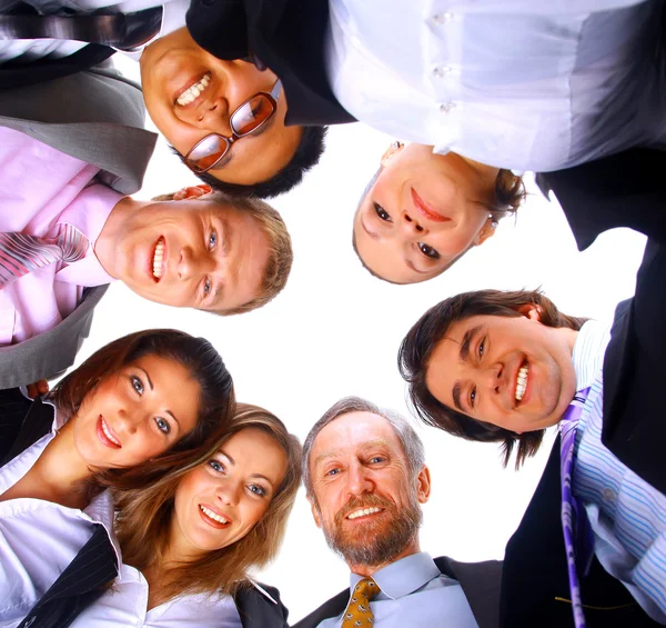 Group of business standing in huddle, smiling, low angle view