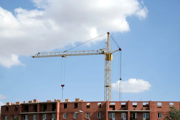 Lifting crane on sky background .