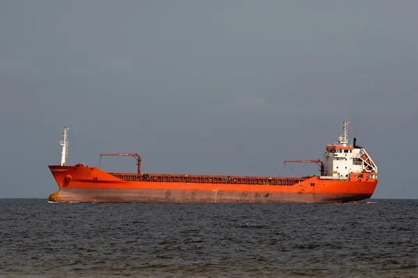 Large red tanker ship in open sea