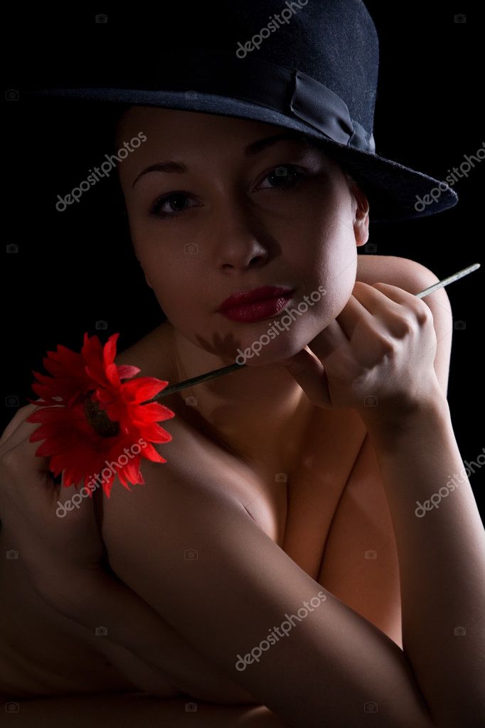 Young nude girl isolated on black background