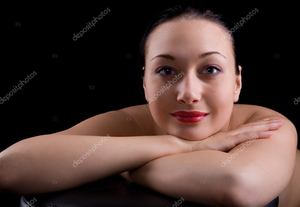 Young nude girl isolated on black background