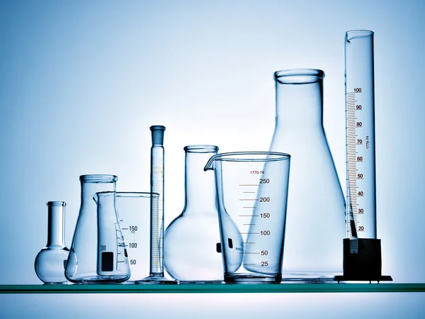 Laboratory glassware on blue background