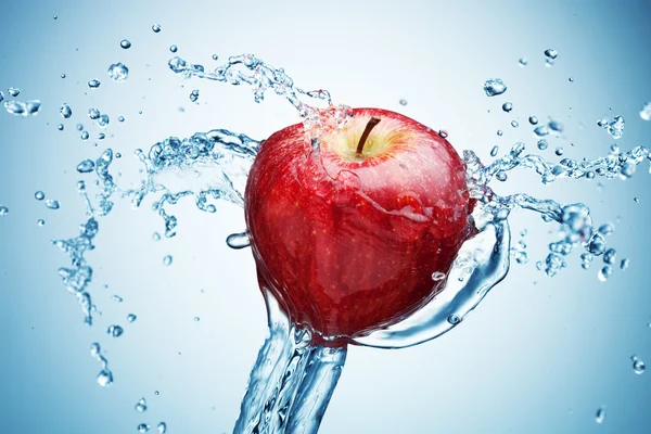 Apple in spray of water.