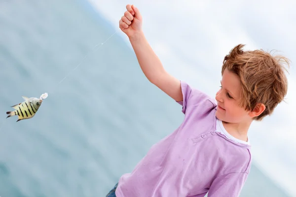 boy holding fish