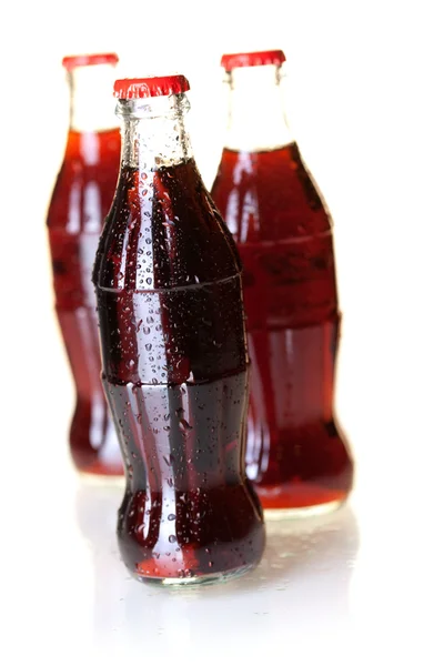 Three bottles of cold cola