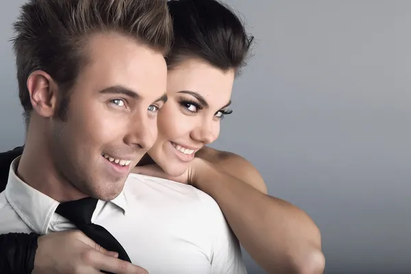 Young attractive couple on grey background