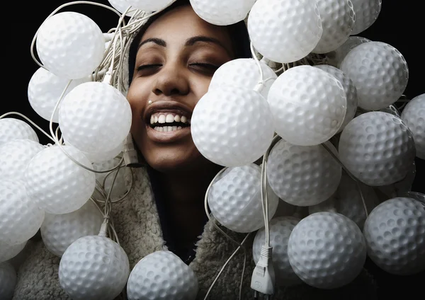 Portrait of African woman covered with fixtures in form of ball for a golf — Stock Photo #3881624