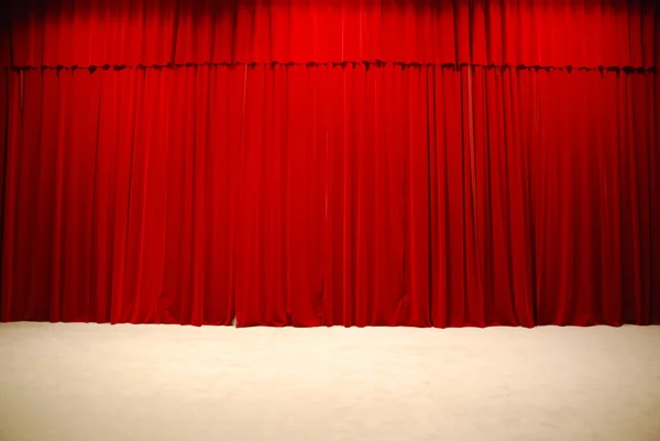 Red draped theater stage curtains