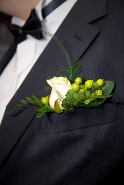 Wedding buttonhole with rose on mans suite
