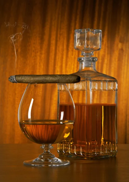 Glass of whisky with cigar