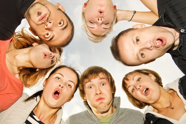 Group of happy friends making surprised faces