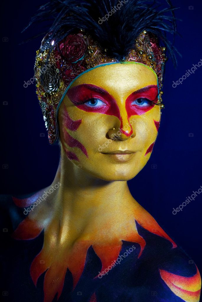 Portrait of a mysterious woman with artistic makeup on her body