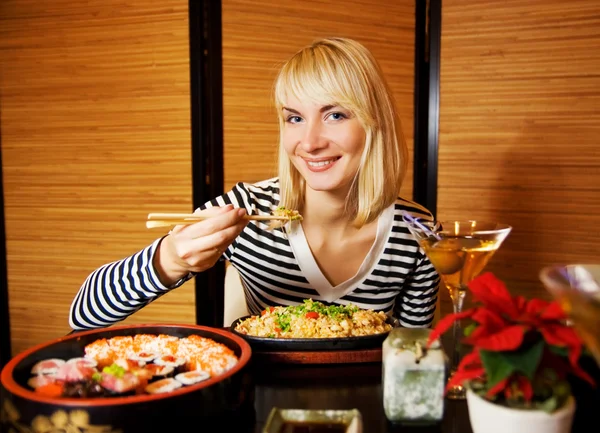 Beutiful blond girl in japanese restaurant