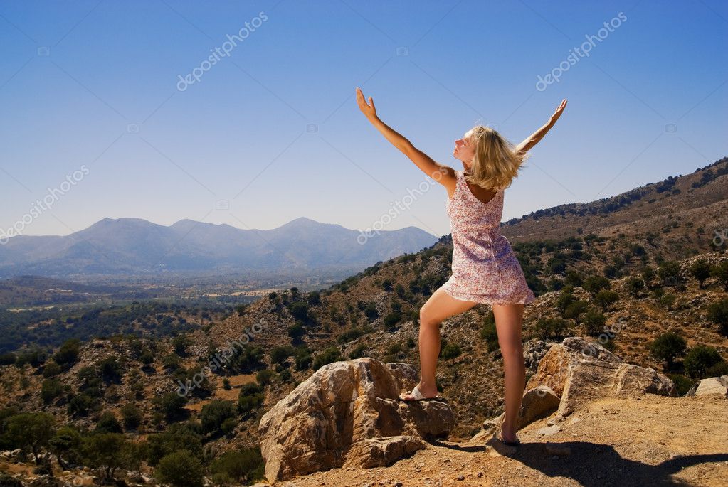 Beautiful Girl Standing On A Mountain With Her Hands Wide Open Stock