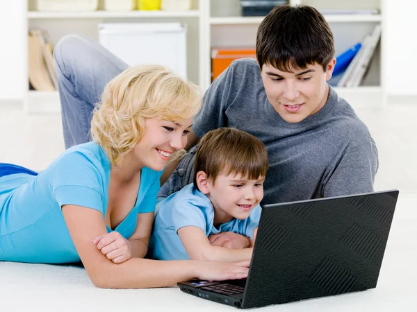 Happy family looking in laptop together