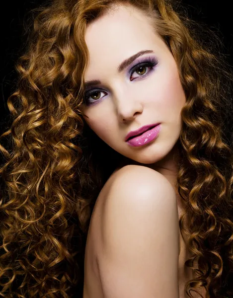 Beautiful woman with long curly hairs