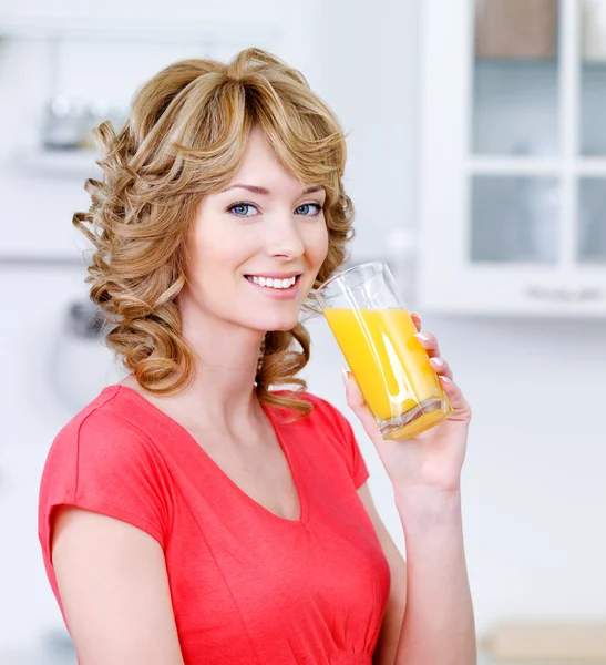Smiling woman with a glass of juice