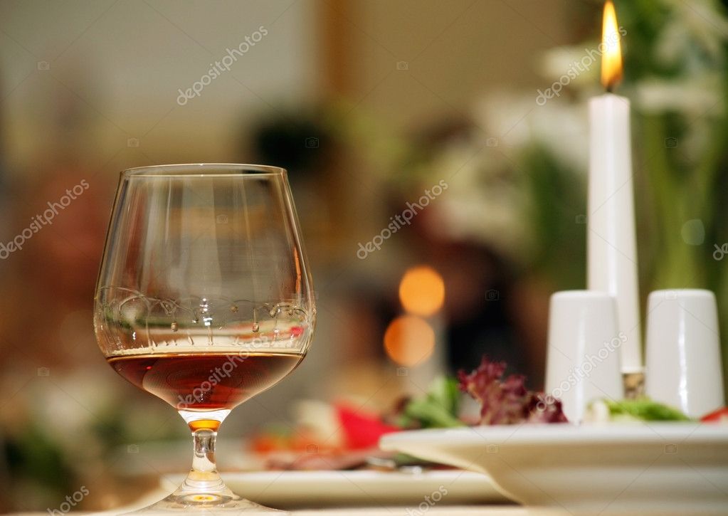 A glass of red wine is on a beautiful holiday table