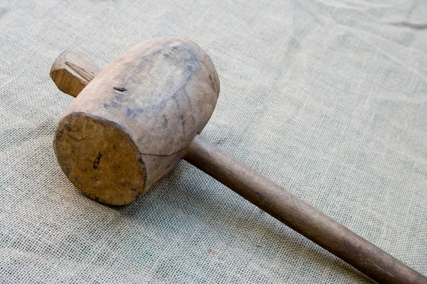 Old wooden mallet hammer on burlap background — Stock Image #3662811