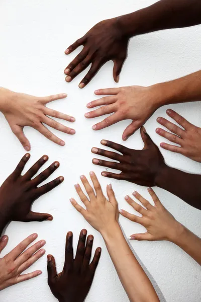 Many hands of persons of various nationalities