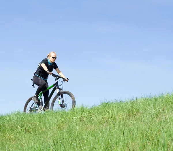 Young woman riding on mountain bike