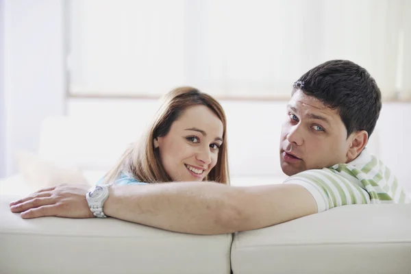 Couple relax at home on sofa