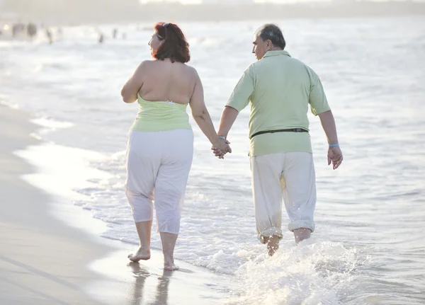 Happy seniors couple on beach