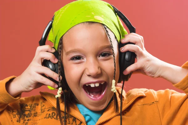 Child listening music in headphones