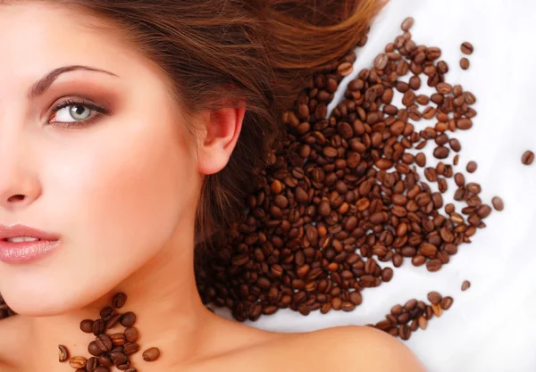 Woman's face with coffee beans