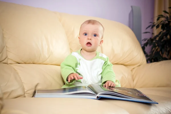 Baby reads a book