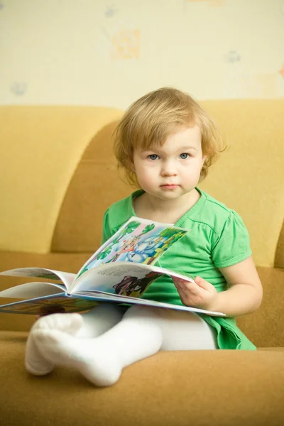 Little girl reads book