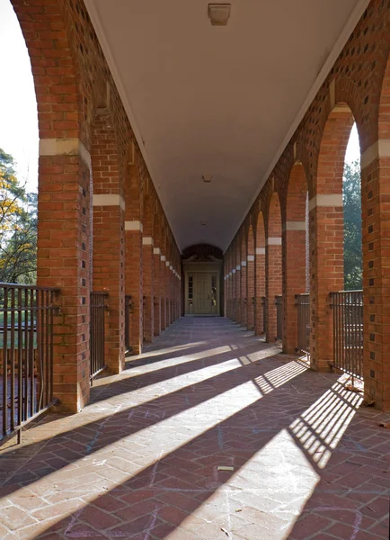 Arched walkway and morning sun vertical