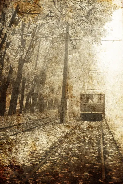 Tramway near autumn alley in Odessa, Ukraine. Photo in old image style.