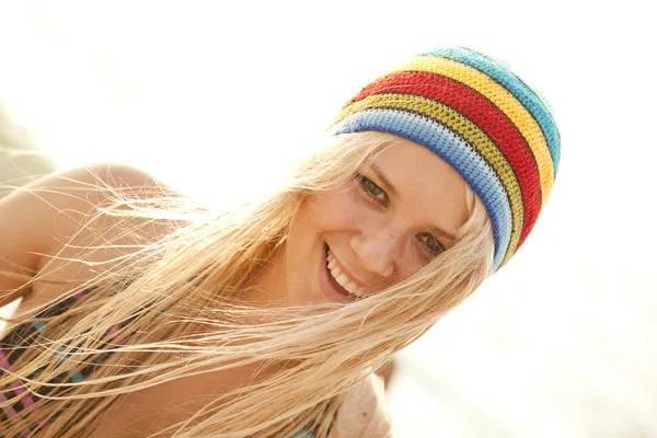 Beautiful young blonde girl in rastafarian hat