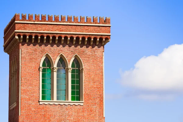 Brick tower with trifora windows