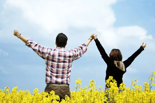 Young couple in a rape field
